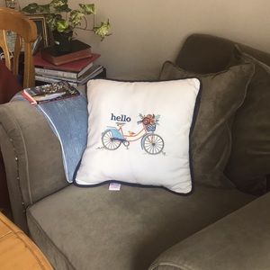 Hello pillow featuring bicycle with flower basket and bird